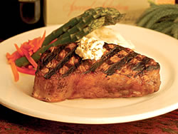 Taste a 16-ounce New York Steak seasoned and grilled to perfection, topped with garlic butter, accompanied with roasted garlic mashed potatoes and grilled asparagus with carrots, paired with Caymus Cabernet Sauvignon "Special Selection." Pr