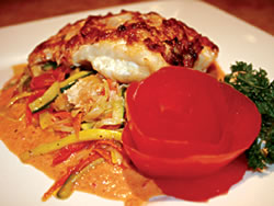 The savoriness of this Catfish Oceanic lies in its crabmeat filling and roasted bell pepper coulis topping. Served with a fresh vegetable medley, this appetizing dish will melt in your mouth. It is best accompanied by a glass of wine from the extensi
