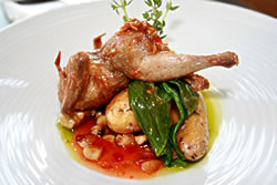 This Manchester Farms Quail, prepared by chef Daniel Otto, is pan fried to perfection with roasted garlic and habaneros. The dish sits atop roasted corn, sweet bell peppers, Russian fingerling potatoes and baby bok choy, and is topped with a basil em