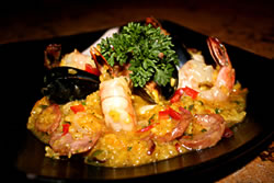 Sinful seafare and mouthwatering meats collide to bring you this tempting dish.  The Paella plate includes shrimp, mussels, calamari, chicken, sausage, red and green bell peppers and red onion and is served alongside a piece of oven-baked fresh bread
