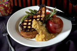 Elmer Dills of KABC Eyewitness News says that The Grille Chop is "A must order... perfection on the bone." This cured center cut, double-thick pork chop with apple cider brine is served with roasted garlic mashed potatoes, asparagus, a bake