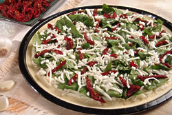 Aegean Pizza combines an olive oil glaze, mozzarella, fresh garlic, spinach, marinated sun-dried tomatoes, feta cheese and oregano on thin dough. No wonder it