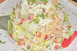 This yummy Southwestern Salad includes spicy chicken, fresh greens, corn, red onion, jack cheese, tomato, pepitas, tortilla strips, Citrus Cilantro dressing and a topping of cilantro. <strong>Wolf Creek Restaurant and Brewing Co.</strong> is located