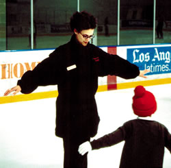 Figure skating instructor and cancer survivor Emily Weirich works with one of her students, Farid Adibe
