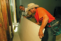 Myron Kalebjian checks on floor installation