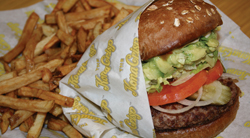 The <b>Cal Kona-Style Burger</b> on Wheat Bread features weet and tangy island teriyaki sauce and lots of fresh avocado, served with mayo and all the produce, which includes crisp lettuce, ripe tomato, sweet onion and a dill pickle wedge. <b>The Kona