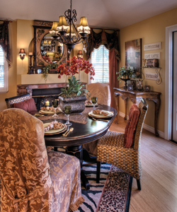 A French door, which opens to the side yard, sheds a bounty of natural light in the dining room. The table was a butcher block that the homeowner painted black.