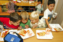 Kindergarten students Devin Manjarrez, Sam Riddle, Jackson Bourne and Tyler Goeckeritz spend their lunchtime laughing and checking out each other