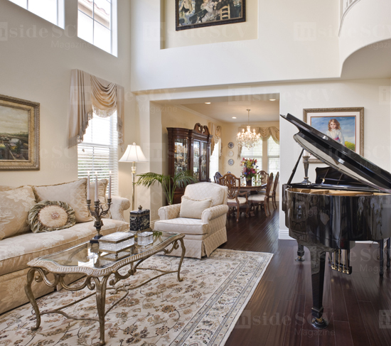 Delmarter was a piano teacher and church pianist, so room for a baby grand was essential. "We wanted the living room to be open, airy and casual," says Tammy. The rug was purchased at Brent