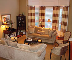 Alternating stripes of cream and taupe were used to create the window treatments.  Horizontal stripes were chosen over vertical stripes to make the traditional room a bit more casual.