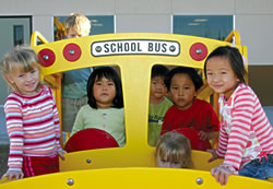 Sydney Young, Chloe Arnott, Emily Cho and Christian Kim enjoy playtime in their little yellow school bus.