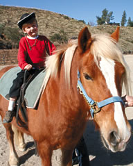 Joaquin Hemstreet, a Carousel Ranch rider, enjoys his lesson at the new property.