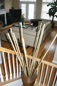 Bamboo stalks can be arranged simply but can make a dramatic statement. These pieces lift the eye up towards an elegantly extended ceiling while posing little distraction to the overall look of this comfortable space.