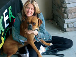 Stephanie Duke, owner of Starpups Depot, cuddles a rescue from the Boxer Rescue before he leaves for his new home. Starpups Depot is celebrating one year in business in June.