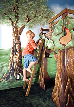Matthew climbs up his new tree house bed courtesy of Dream Themes. The sleeping area was built with safety in mind. Dee Dee Cooper of Cooper Designs painted the bed to coordinate with the room