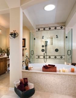 The master bath is a point of pride for the family. The gorgeous frame-less, glass-enclosed shower boasts one-half-inch glass and was custom created by B & D Glass & Windows. The deep-bronze shower accoutrements, including the adjustable-rod shower h