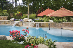 A mildly-sloped beach entry, created with both children and adults in mind, is dotted with umbrellas.