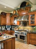 Stainless steel appliances, cherry cabinetry and Italian decor define the kitchen.