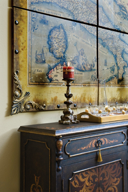 The ornately-scrolled buffet table in the dining room coordinates perfectly with the Old World map of Italy located just above.