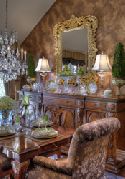 An antique guilded mirror is flanked by lamps circa the 1920s. The sentimental light fixtures were previously on display in Cheryl