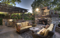 This hearth-side gathering place was once an outdoor dining room. The fire screen, candlesticks and travertine-topped table were acquired from the Laviabella.com collection.