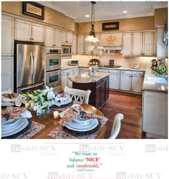 above Refinished cabinets brighten the kitchen, while decorative scrollwork by Murals by Pam adds interest and depth to the space.