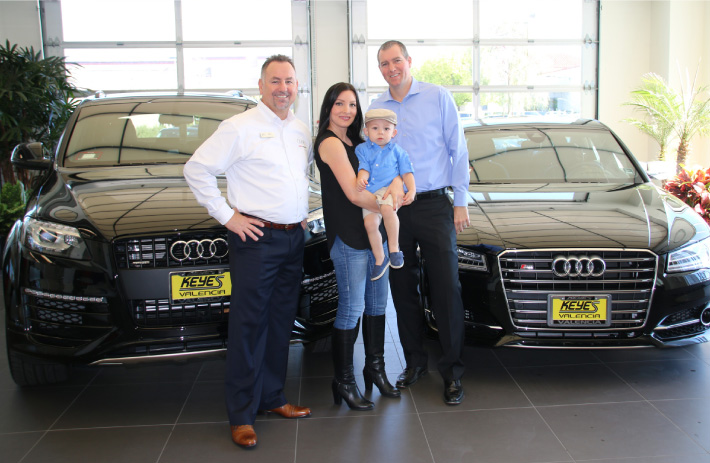 Mike and Kimberly Hrezo with baby Benjamin and  Audi Valencia General Manager Rob Smith.